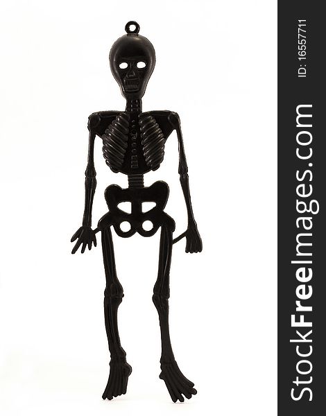 Black Plastic Skeleton Over White