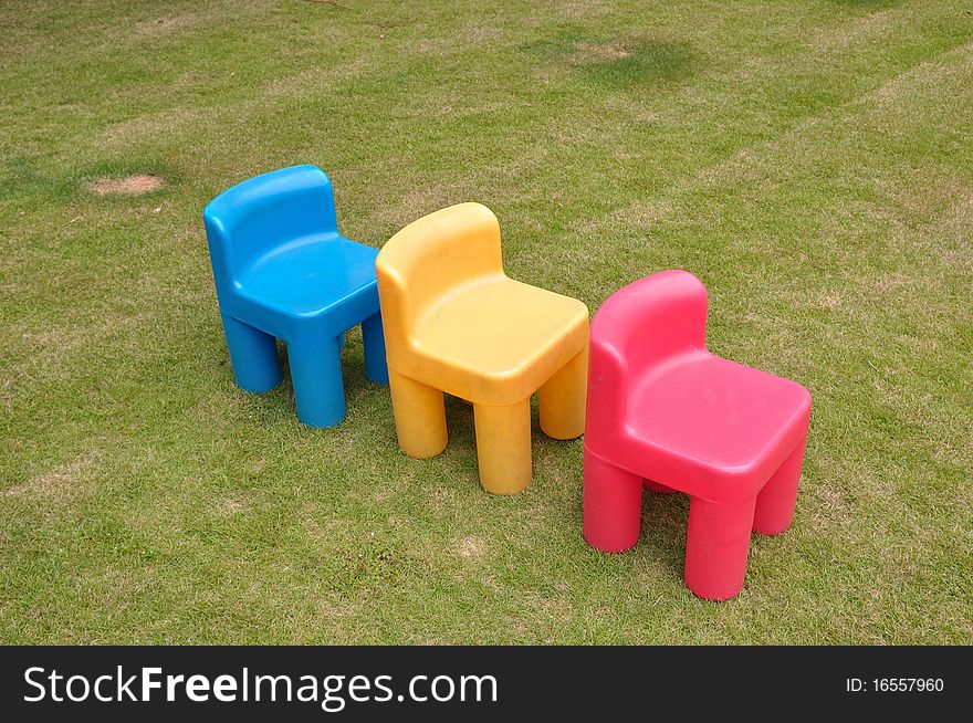 Three chairs on the grassland