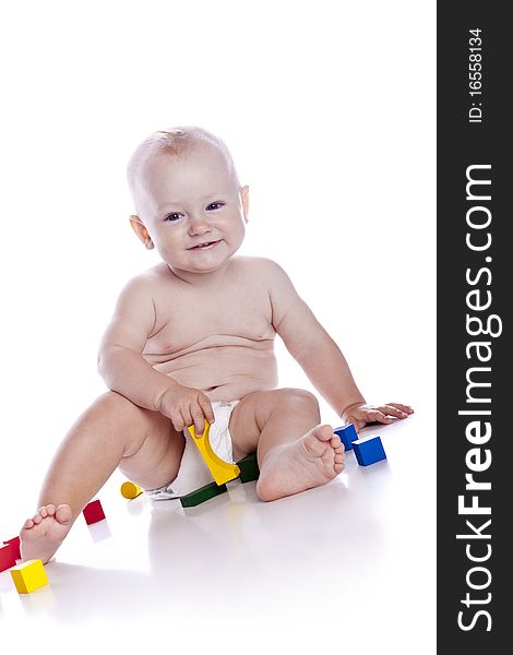 The Kid Plays With Cubes On A White Background