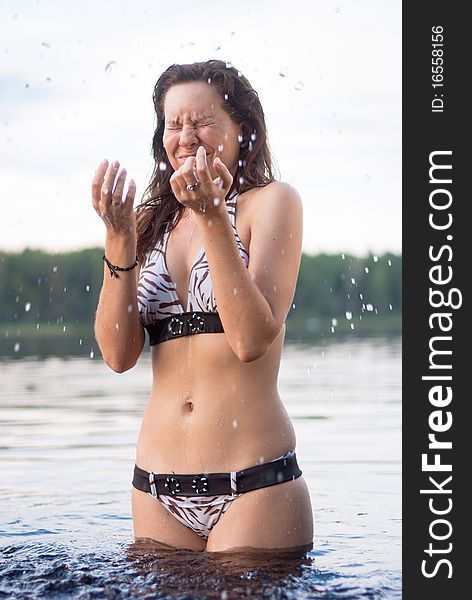 Woman posing in lake water in sunshine. Woman posing in lake water in sunshine.