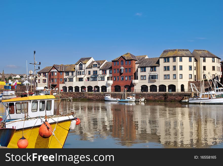 View of a yellow boat and Modern apartmrnts on the quayside at Maryport, Cumbria, England. View of a yellow boat and Modern apartmrnts on the quayside at Maryport, Cumbria, England