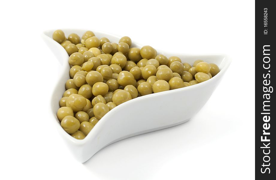 Green peas in a dish on a white background