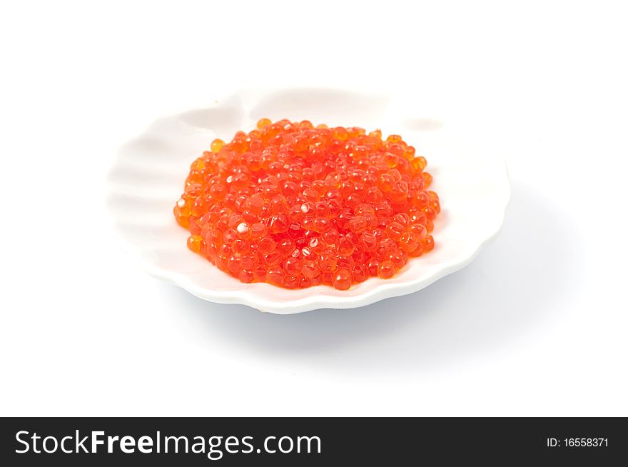 Red caviar on the plate on a white background