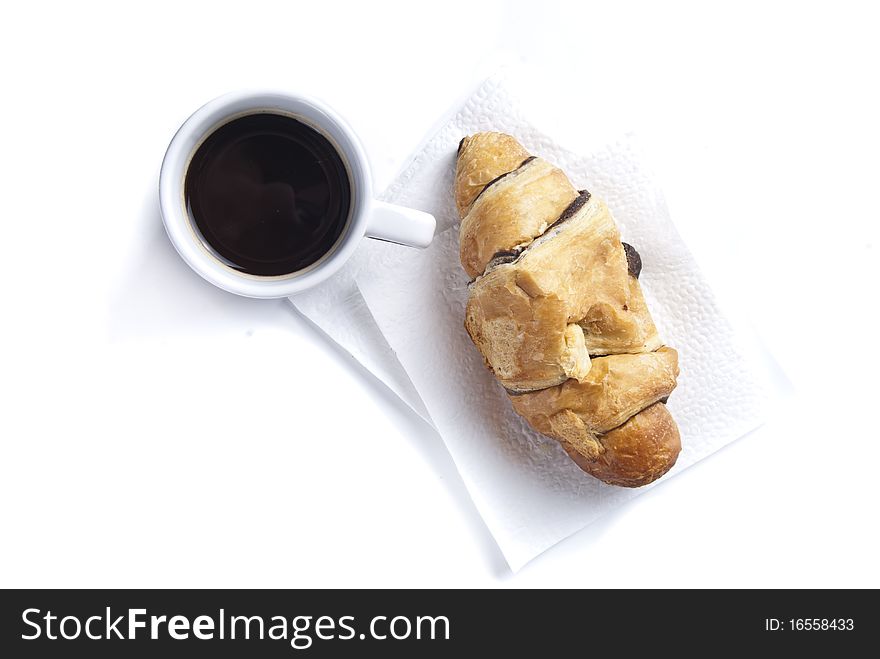 Coffee cup and croissant against white background. Coffee cup and croissant against white background