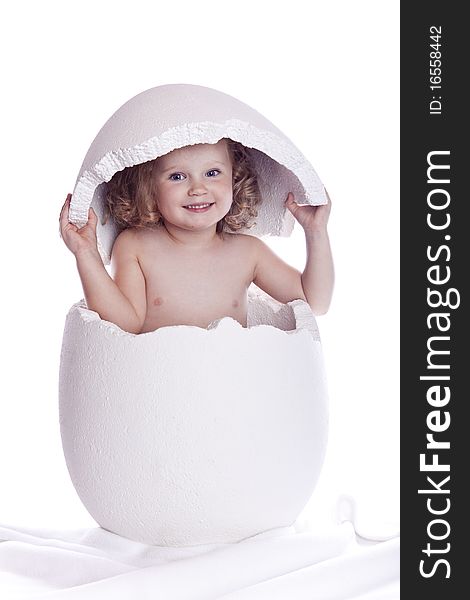 Baby in egg on white background