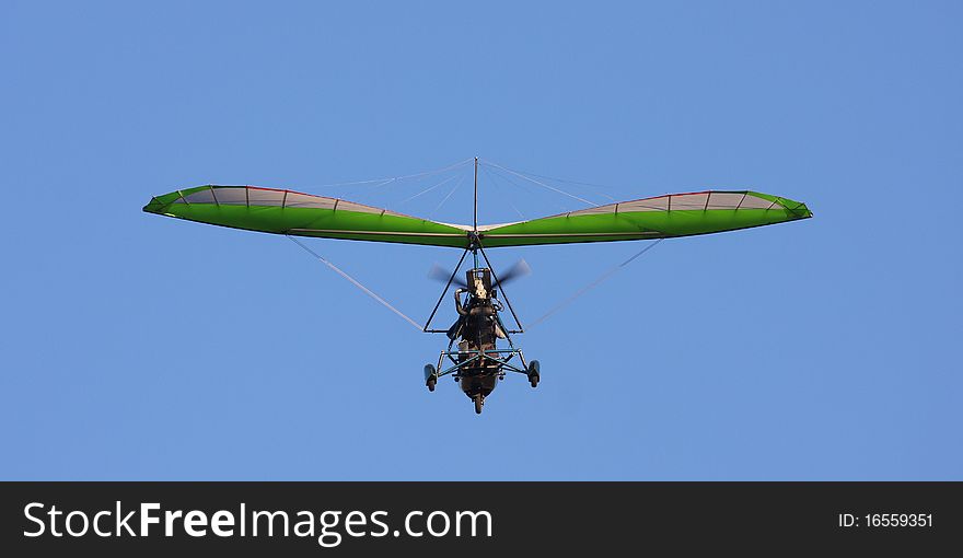 Green motor deltaplan. Blue sky. Green motor deltaplan. Blue sky.