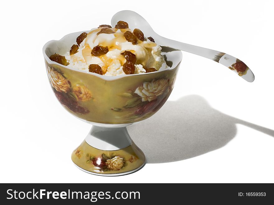 Cottage cheese with honey and raisin in a beautiful porcelain vase. Cottage cheese with honey and raisin in a beautiful porcelain vase