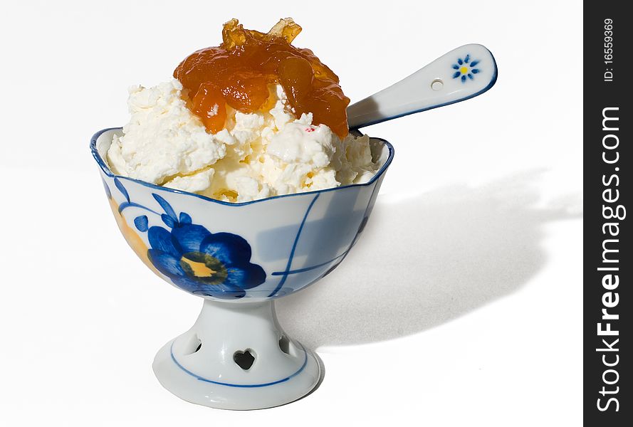 Cottage cheese with jam from apricots in a beautiful porcelain vase. Cottage cheese with jam from apricots in a beautiful porcelain vase