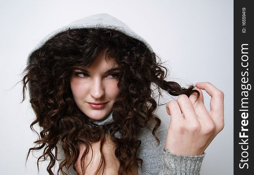 Young girl in hood playing with her hair