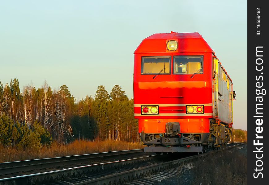 Russia. Red passenger locomotive at evening