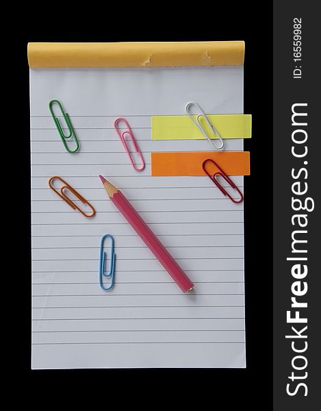 Mini notebook and colorful clip as black background