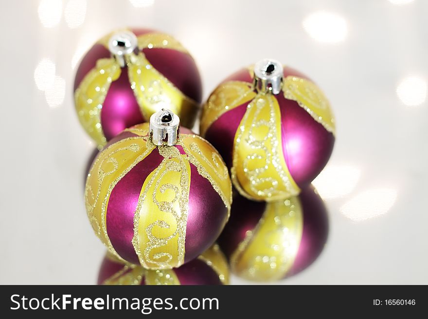 Three red Christmas ball on a background of lights