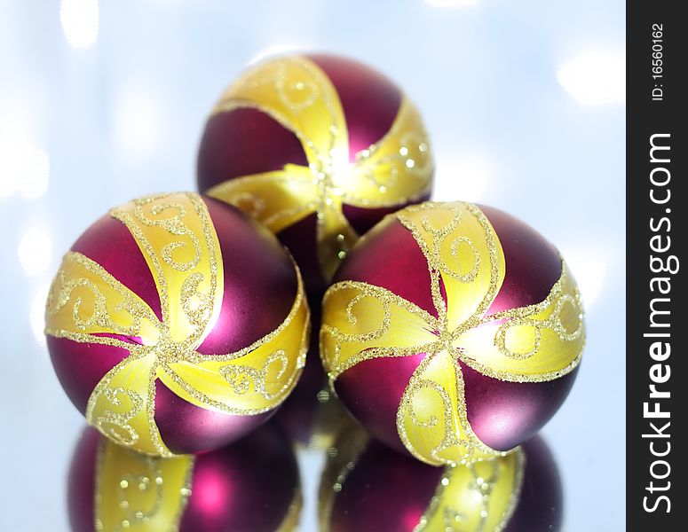 Three red Christmas ball on a background of lights