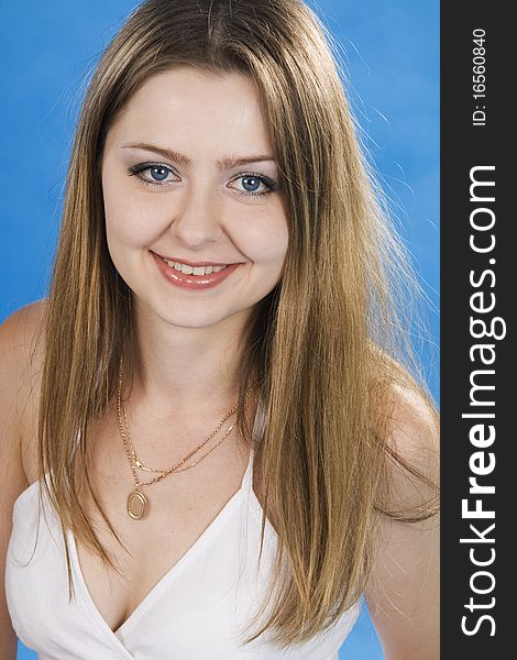 Beautiful woman smiles on a blue background