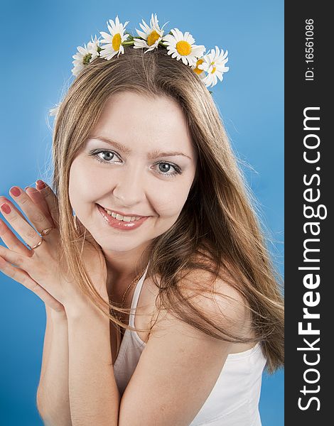 Beautiful woman smiles on a blue background