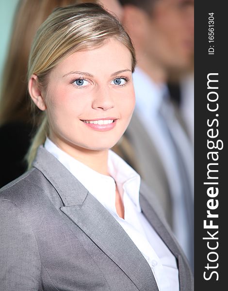 Businesswoman standing in front of group in the office. Businesswoman standing in front of group in the office