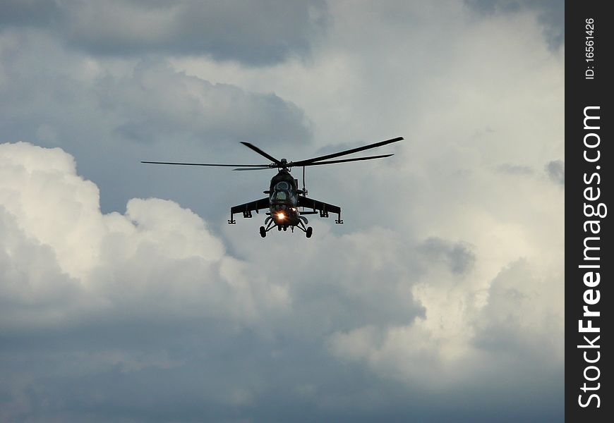 A military helicopter flying at clouds