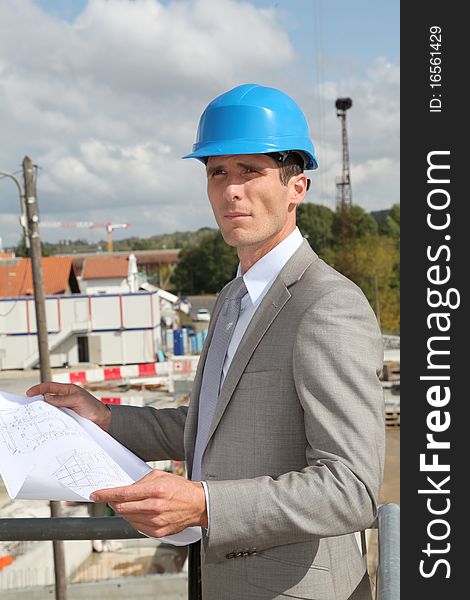 Architect Standing On Building Site