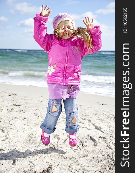 Cute young girl having fun on the beach