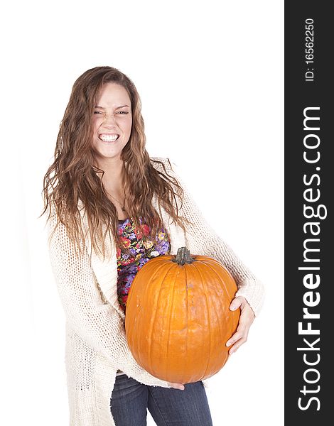A woman is holding a large pumpkin. A woman is holding a large pumpkin.