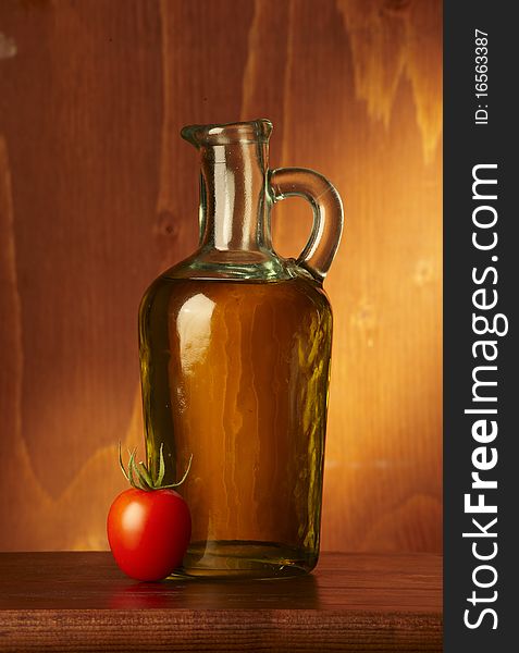 Bottle with olive oil on wood