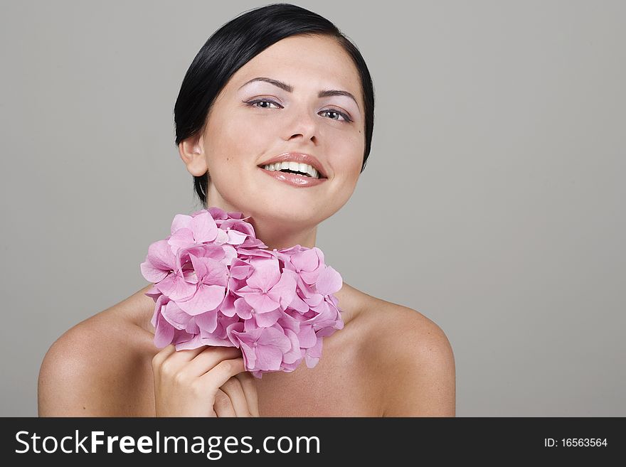 Portrait of young and beautiful woman with flower