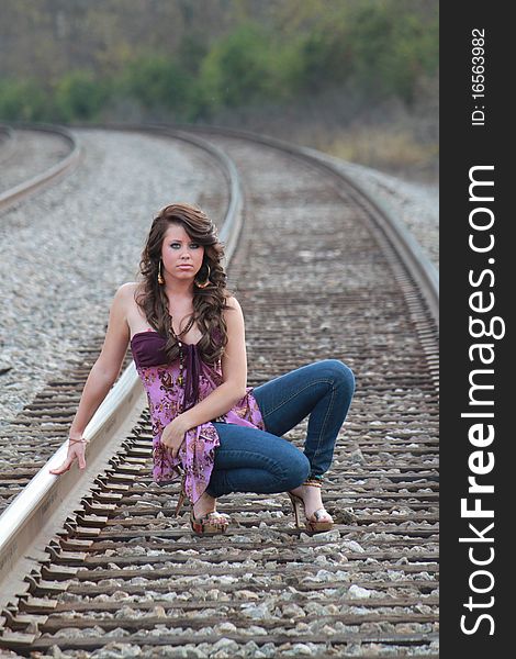 Lovely young lady on the railroad track. Lovely young lady on the railroad track.