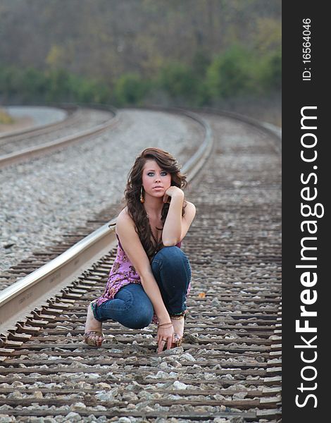 Lovely young lady on the railroad track. Lovely young lady on the railroad track.