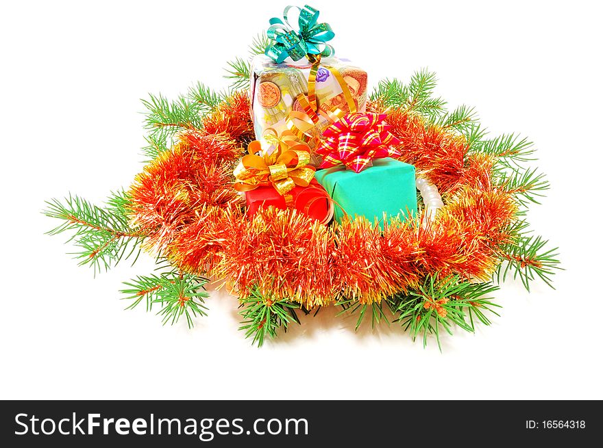 Christmas gifts on fur-tree branches isolated on a white background