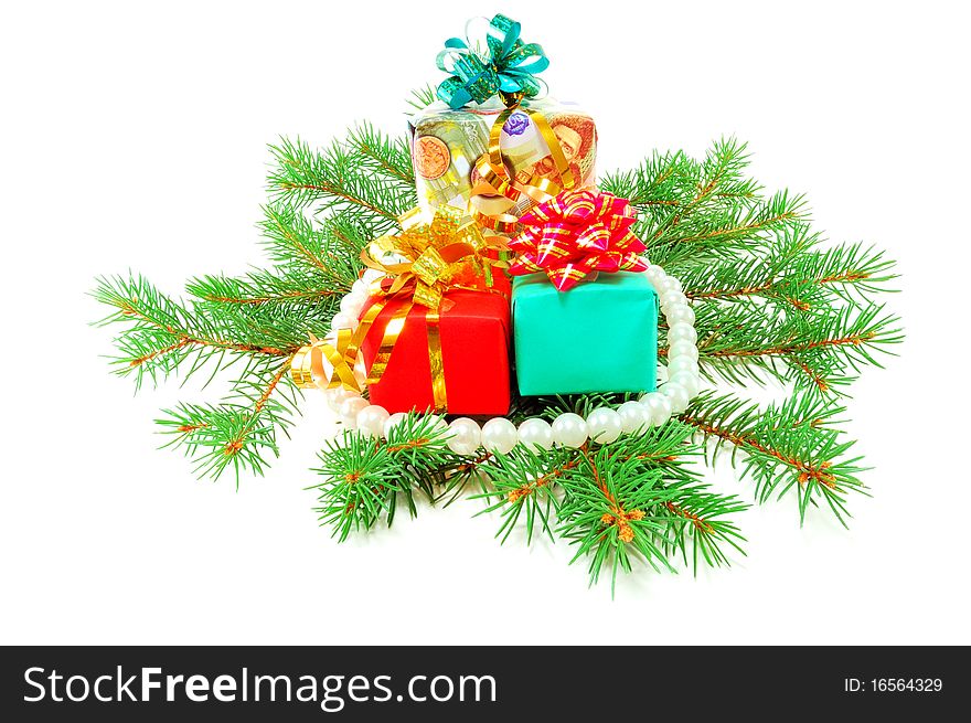 Christmas gifts on fur-tree branches isolated on a white background