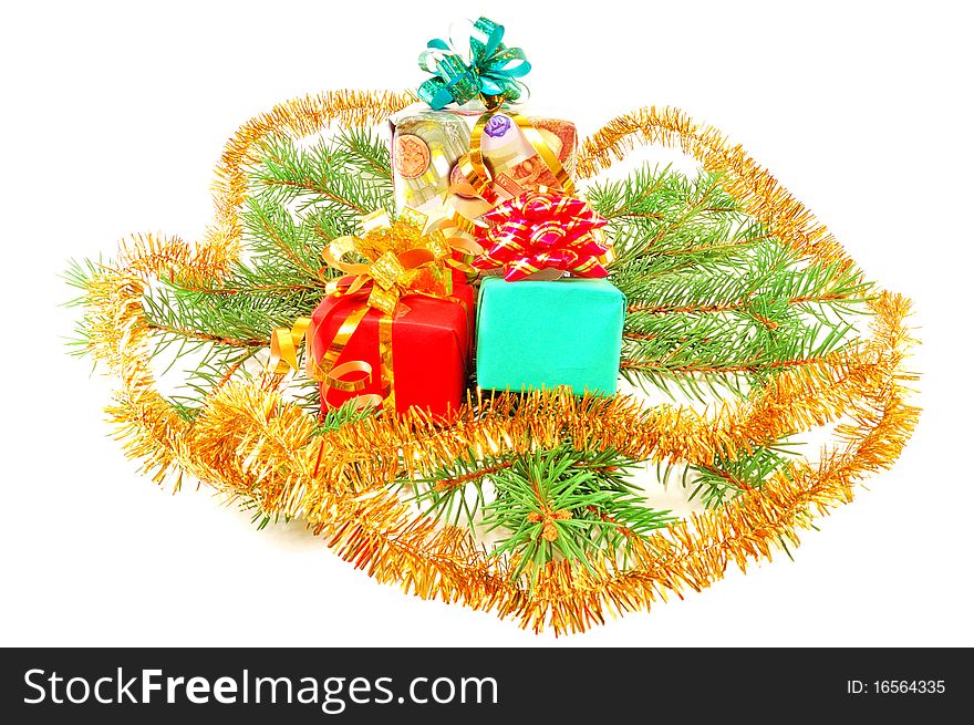 Christmas gifts on fur-tree branches isolated on a white background