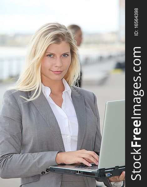 Blond businesswoman with laptop computer. Blond businesswoman with laptop computer