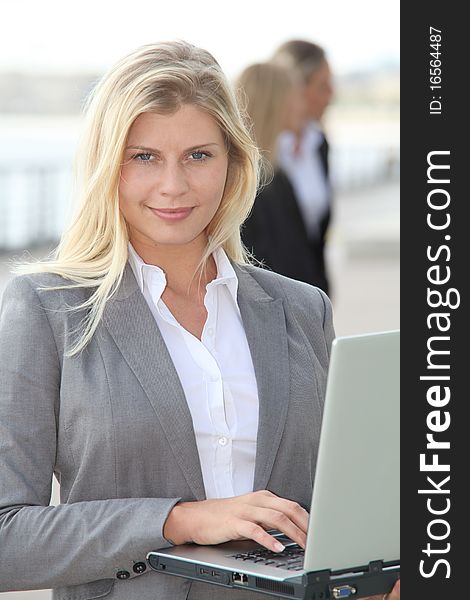 Blond businesswoman with laptop computer. Blond businesswoman with laptop computer