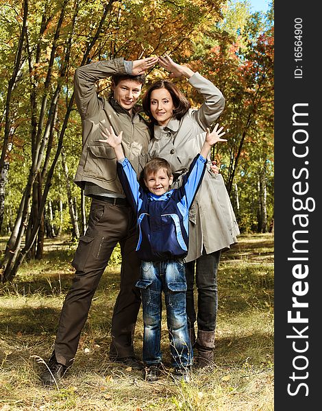 Happy family walking at the autumn park. Happy family walking at the autumn park.