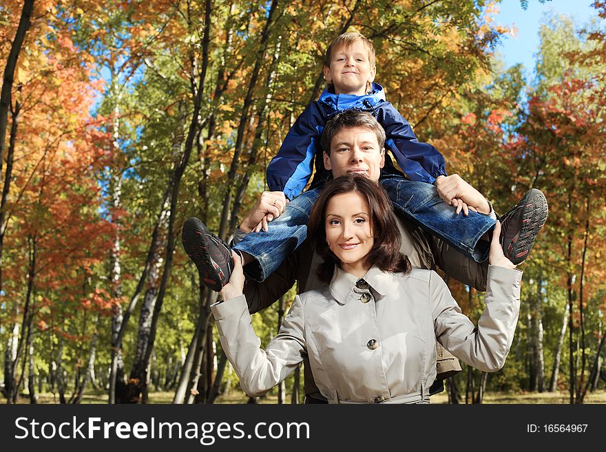 Happy family walking at the autumn park. Happy family walking at the autumn park.