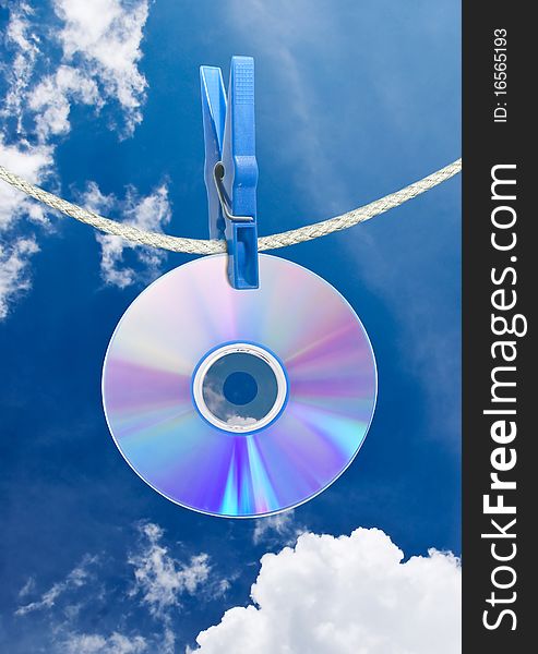 Cd on rope with clothes pin over blue sky