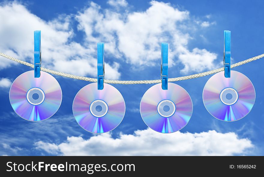 Cd on rope with clothes pin over blue sky background