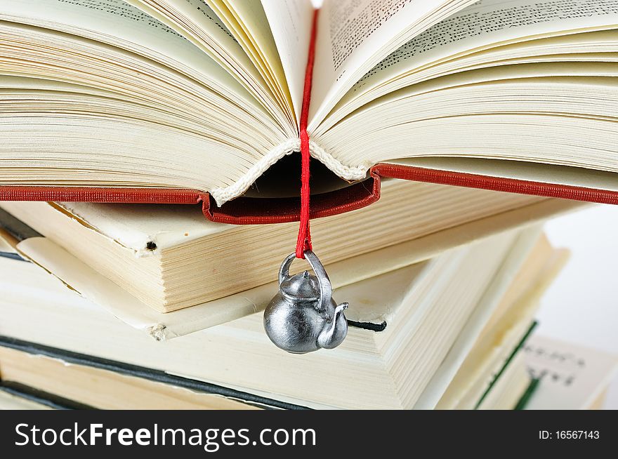 Stack Of Used Books With A Hand-made Bookmark