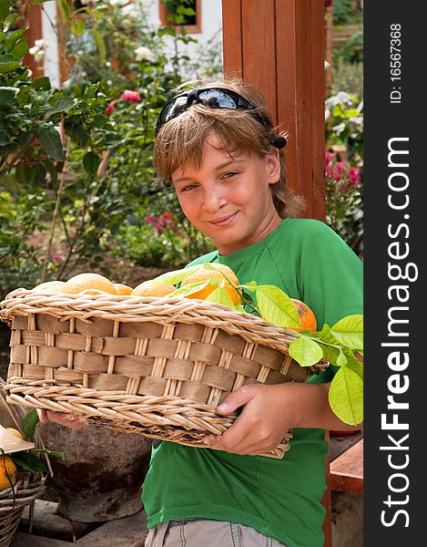 A boy carries a basket of oranges. A boy carries a basket of oranges.