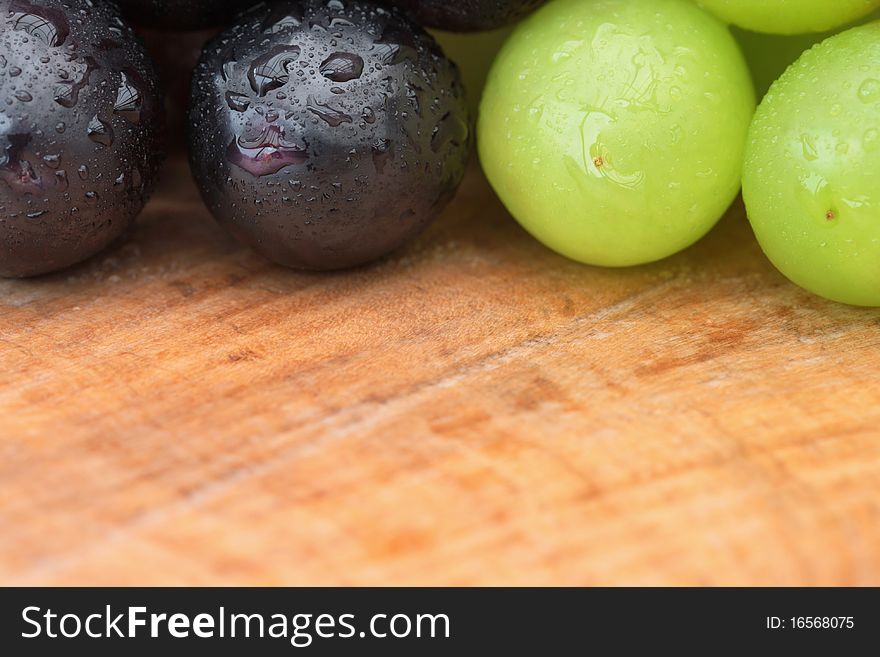 Grapes with water droplets on outdoor table, close-up with copy space. Grapes with water droplets on outdoor table, close-up with copy space