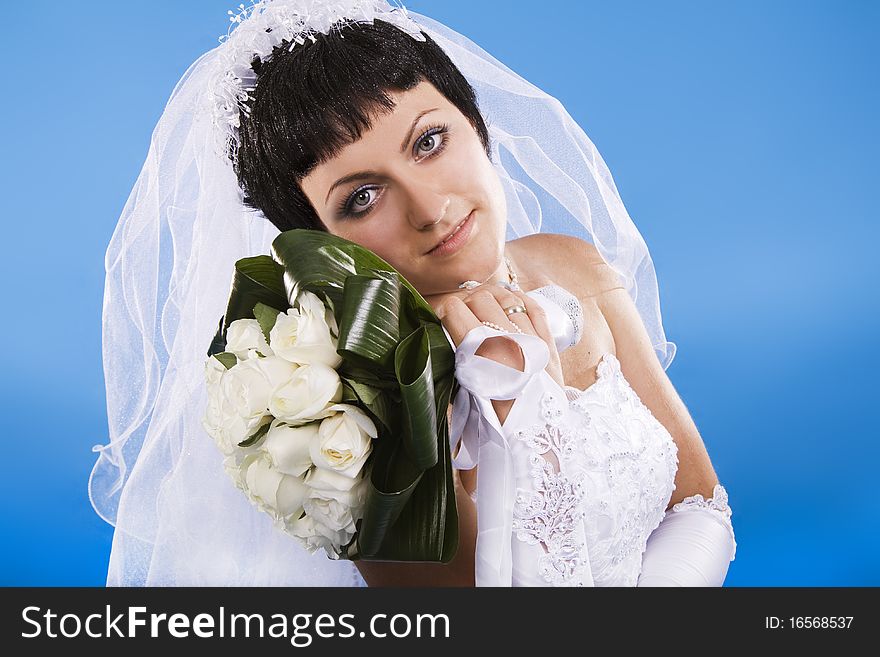 One happy and Beautiful bride on blue background. One happy and Beautiful bride on blue background.