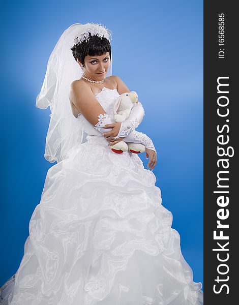 One happy and Beautiful bride on blue background. One happy and Beautiful bride on blue background.