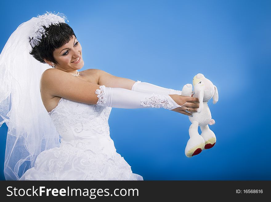 One happy and Beautiful bride on blue background. One happy and Beautiful bride on blue background.