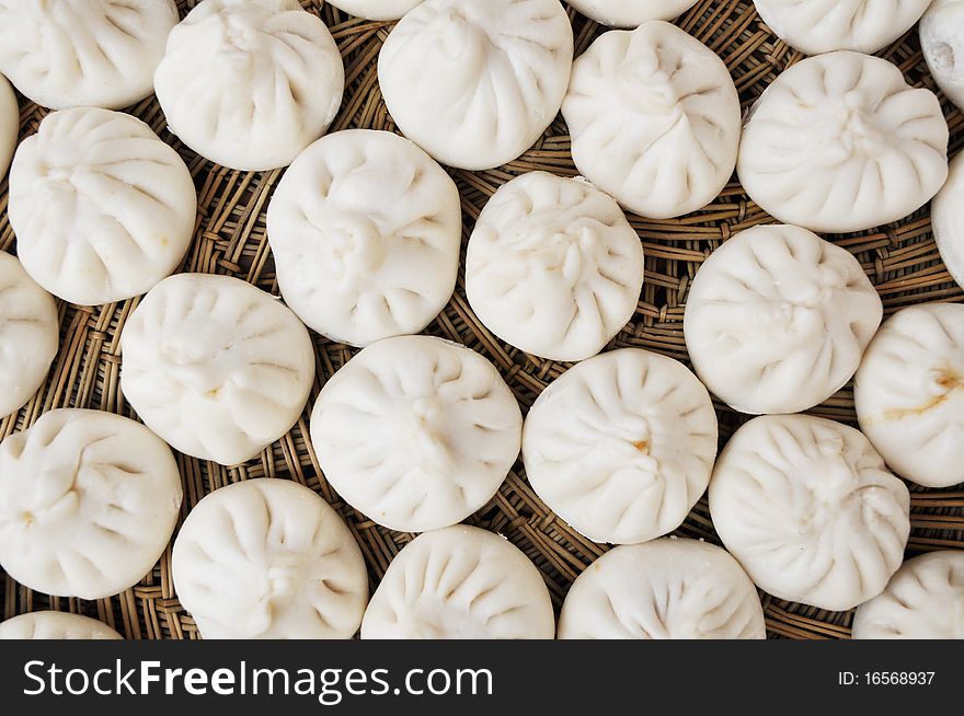 Chinese food of steamed bread with meat fillings in bamboo steamer.