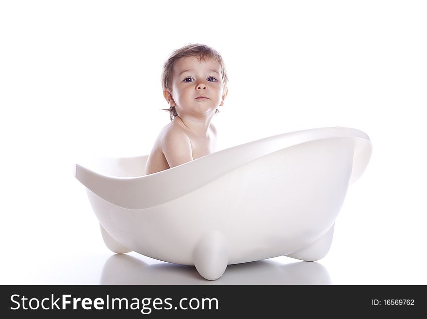 Boy in white bath tub on white background