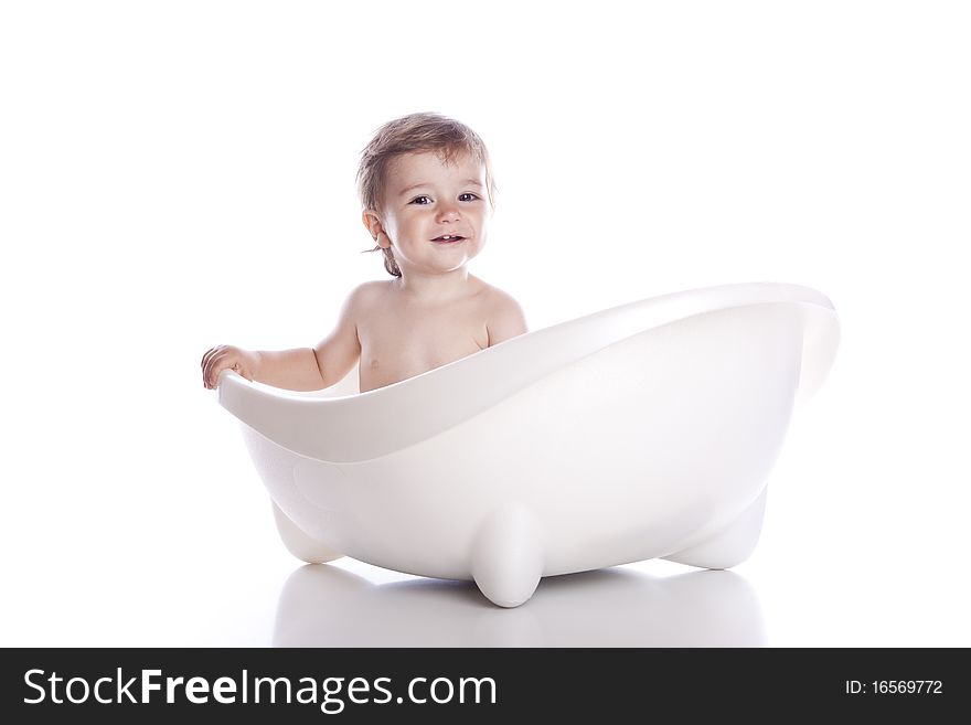 Boy in white bath tub on white background