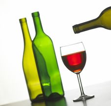 Glass Of Red Wine With Two Green Wine Bottles Stock Images Glass Of Red Wine With Two Green Wine Bottles Stock Images