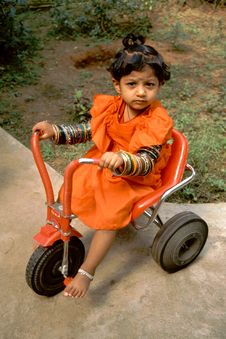 Baby, Bangles And Tricycle Stock Photo
