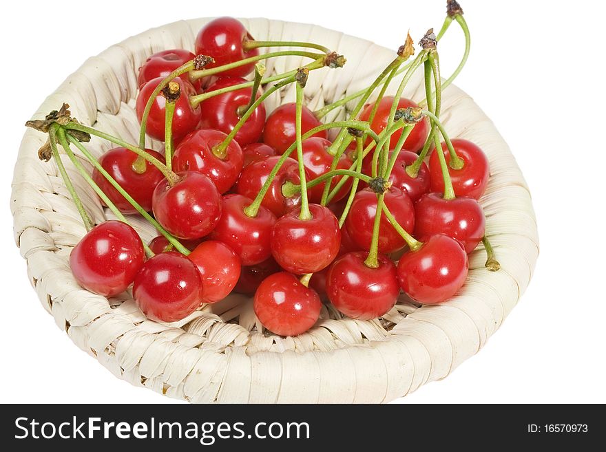 Cherries in a wicker basket isolated on a white background