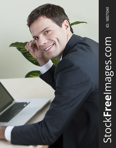 Businessman working on laptop in his office